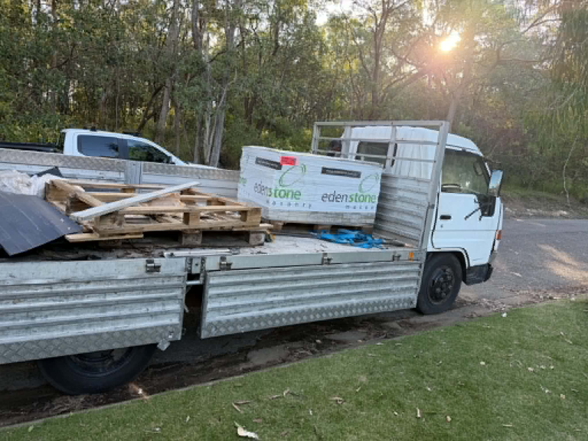 Old flooring and rubbish loaded for removal by Turner Installs
