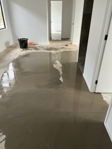 Self levelling compound being used to prepare a floor for installation