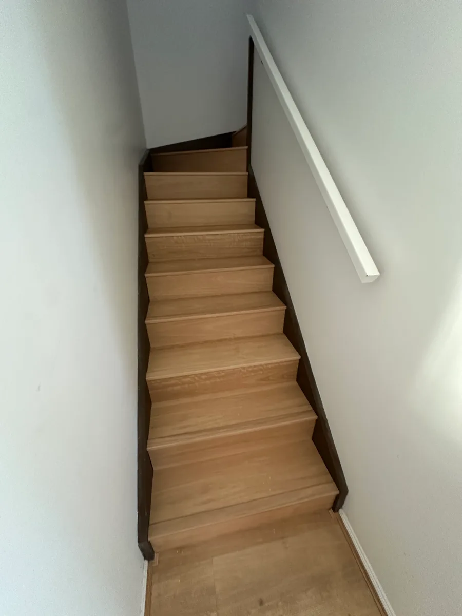 Custom matching nosing detail on Richlands plank flooring stairs