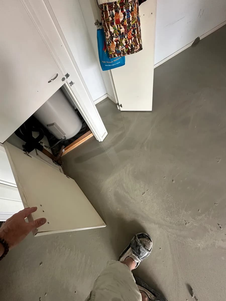 Spring Hill flood coat carried through a doorway during floor preparation