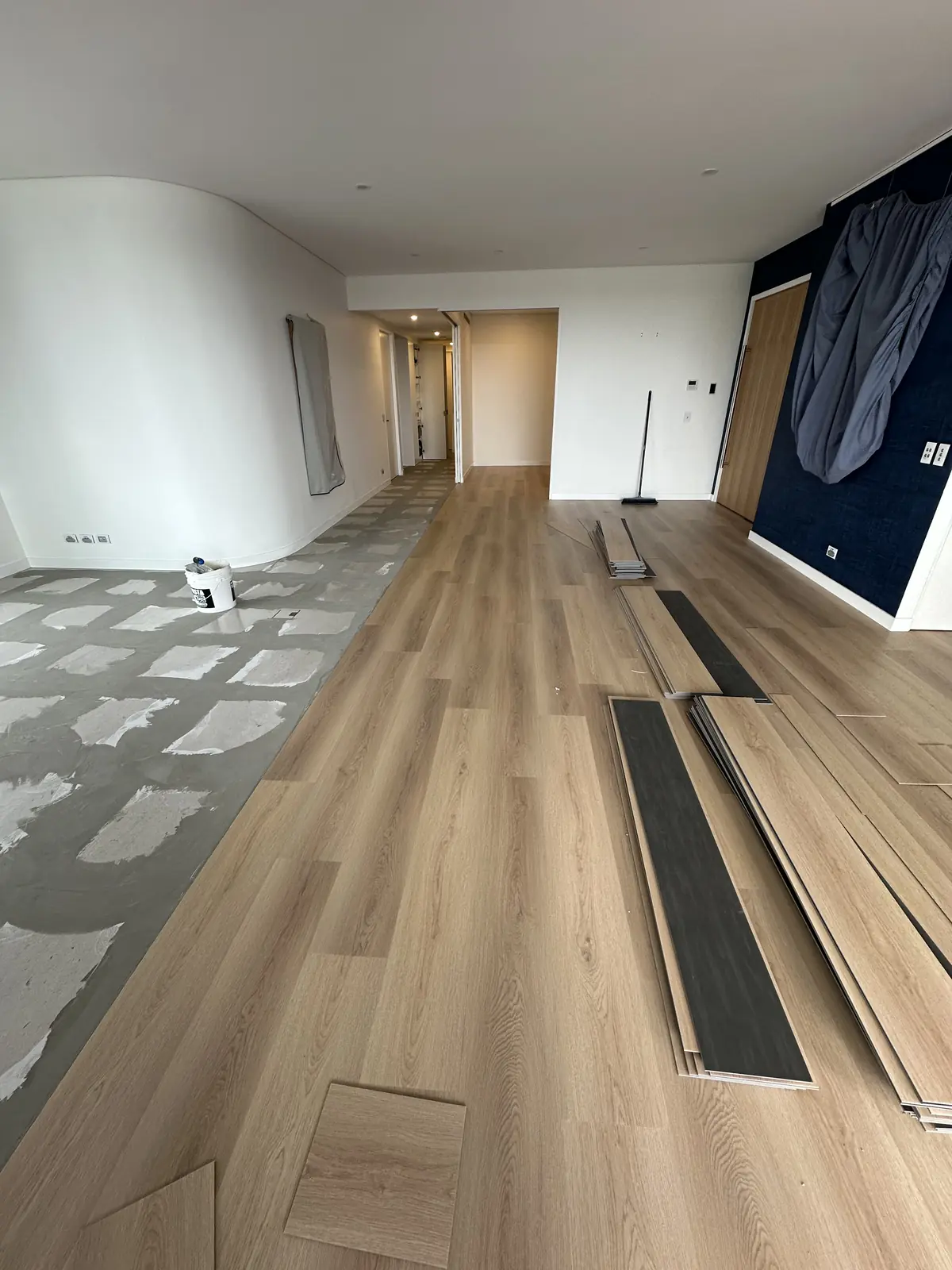 Patched concrete slab beside newly installed plank flooring in a Toowong apartment